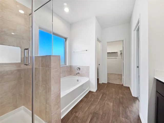 a bathroom with a bathtub a sink and a shower