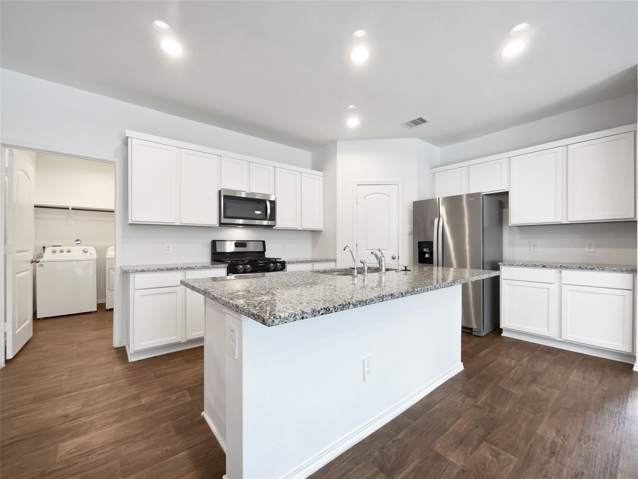 13912 Acadia Point Court Conroe, TX 77384 - Photo 2 of 19 a kitchen with stainless steel appliances granite countertop a sink a stove a refrigerator and cabinets