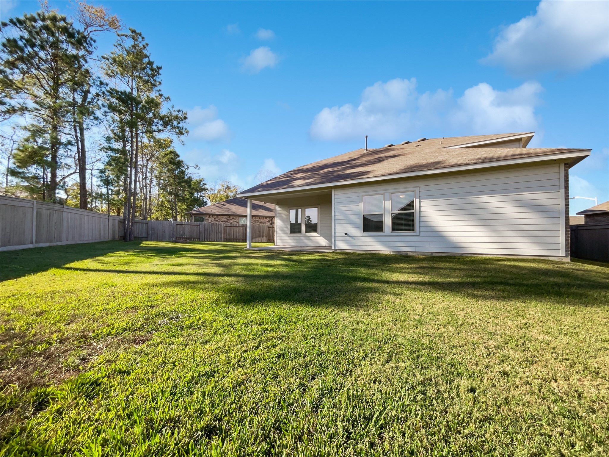 13912 Acadia Point Court Conroe, TX 77384 - Photo 5 of 19 a view of a house with a yard