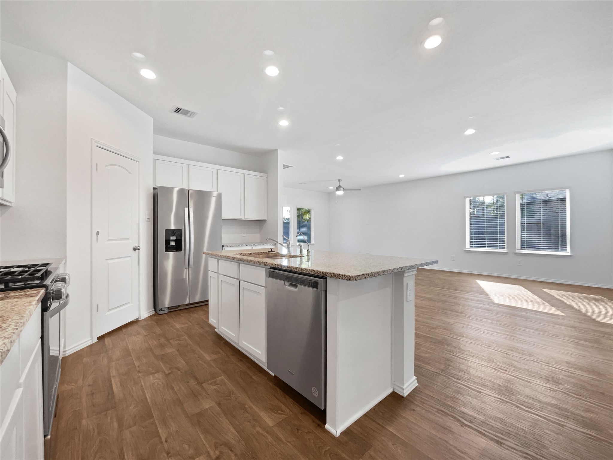 13912 Acadia Point Court Conroe, TX 77384 - Photo 9 of 19 a kitchen with stainless steel appliances granite countertop a refrigerator and a stove top oven