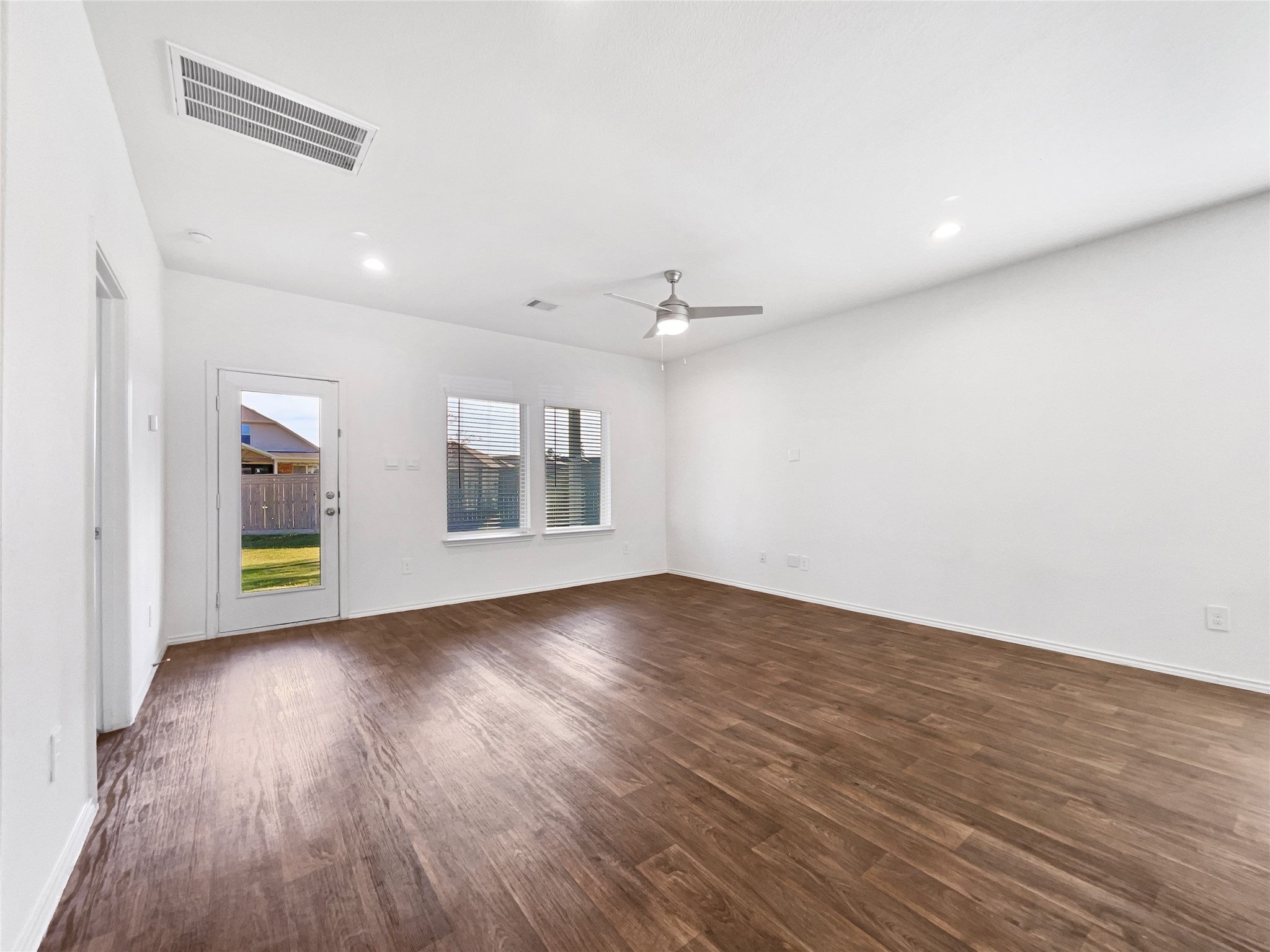 13912 Acadia Point Court Conroe, TX 77384 - Photo 10 of 19 wooden floor in an empty room with a window