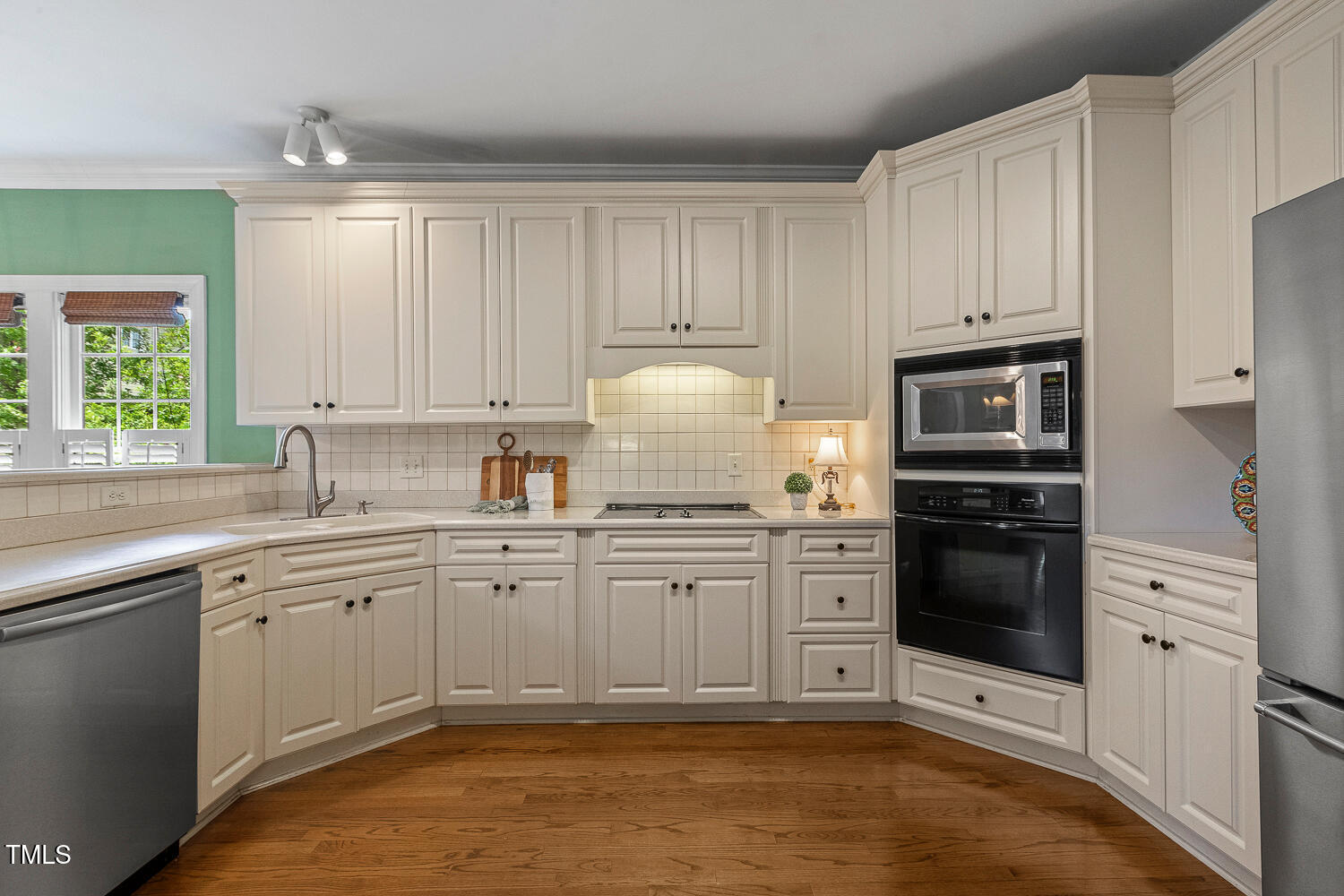 500 Potomac Grove Place Cary, NC 27519 - Photo 13 of 77 a kitchen with granite countertop white cabinets and stainless steel appliances