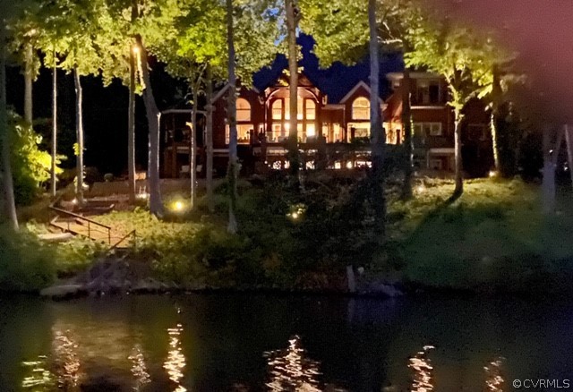 front view of a house with a yard and lake view