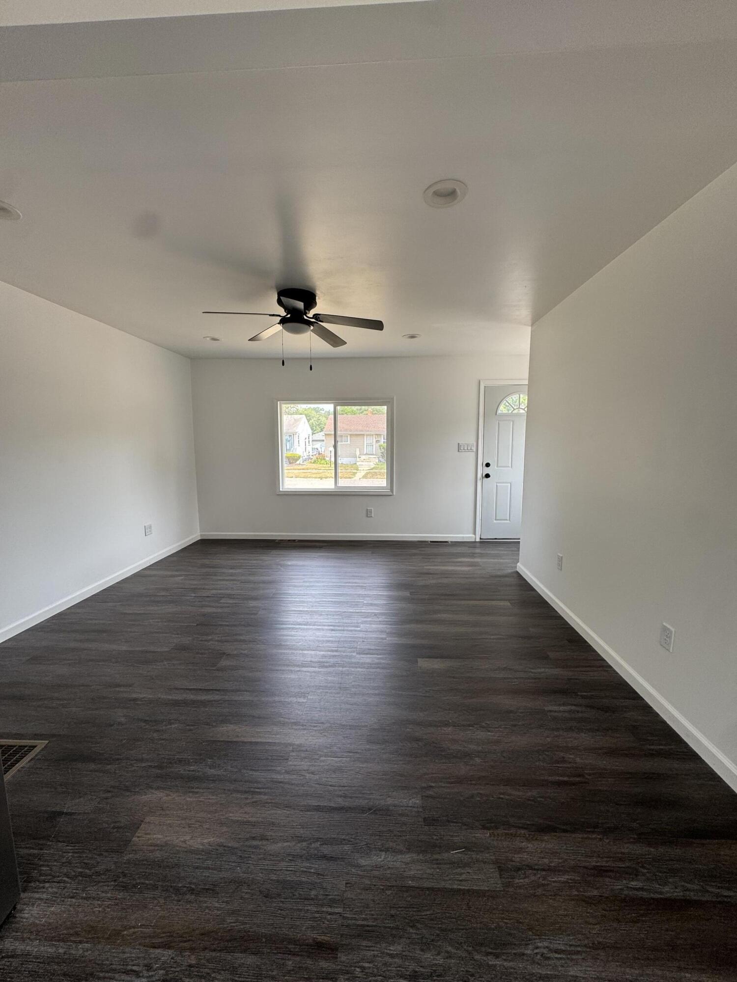 564 Hamlin Street Gary, IN 46406 - Photo 3 of 14 a view of an empty room with wooden floor and a window