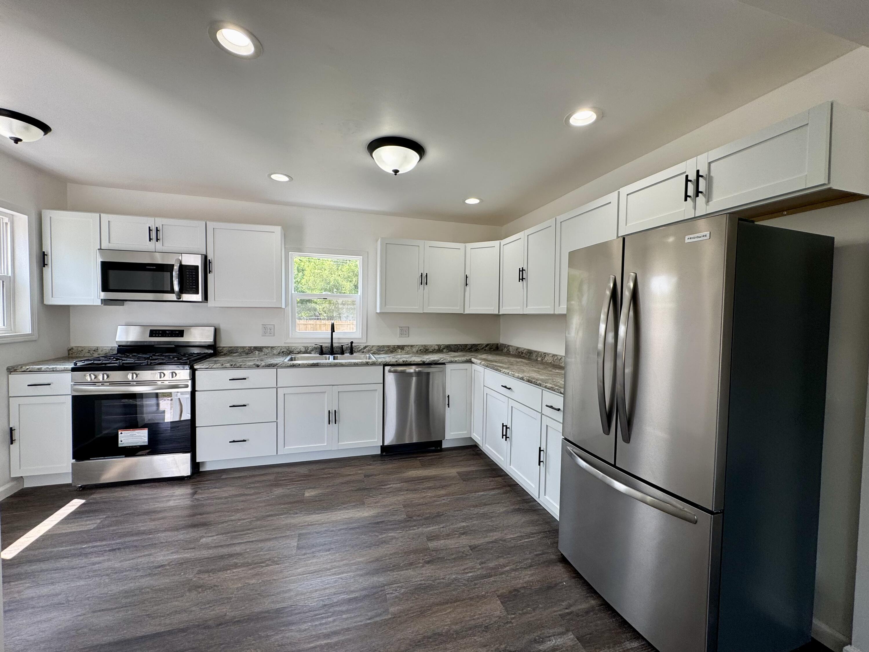 564 Hamlin Street Gary, IN 46406 - Photo 4 of 14 a kitchen with stainless steel appliances a refrigerator sink and microwave