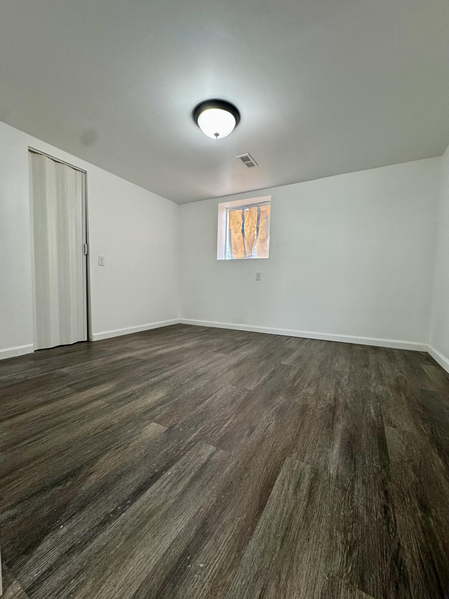 564 Hamlin Street Gary, IN 46406 - Photo 9 of 14 an empty room with wooden floor and windows