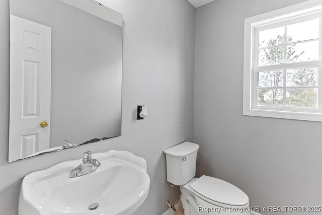 a white toilet sitting next to a white sink