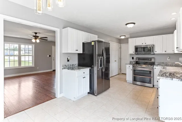 a kitchen with stainless steel appliances a refrigerator sink and microwave
