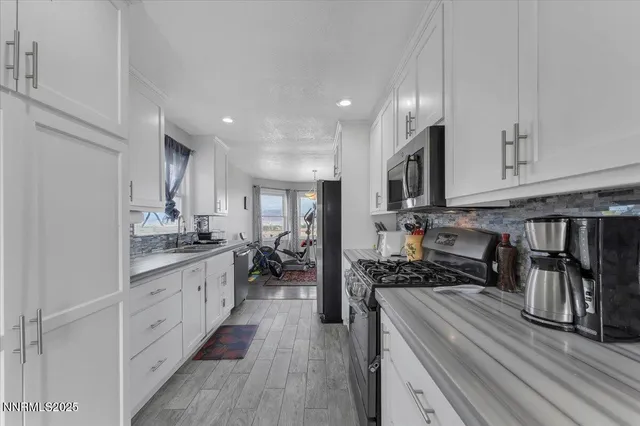 a kitchen with sink stainless steel appliances and cabinets