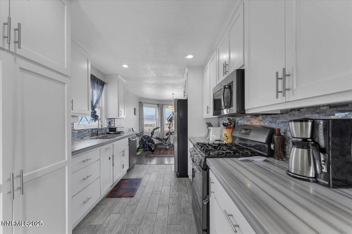 20 Simons Road Fernley, NV 89408 - Photo 11 of 56 a kitchen with stainless steel appliances a refrigerator sink and cabinets