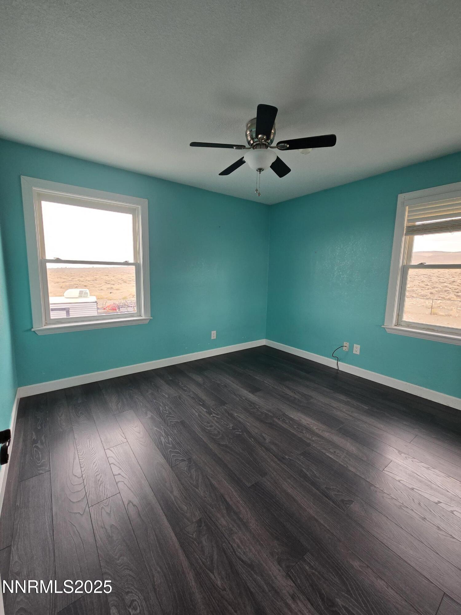 20 Simons Road Fernley, NV 89408 - Photo 16 of 56 a view of an empty room with wooden floor and a window
