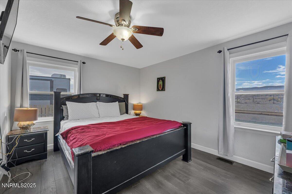 20 Simons Road Fernley, NV 89408 - Photo 23 of 56 a bedroom with a bed and a chandelier