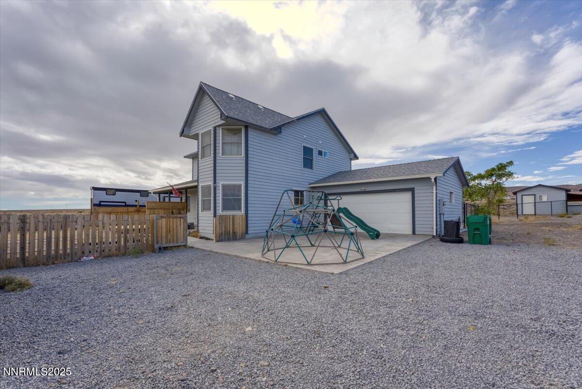 20 Simons Road Fernley, NV 89408 - Photo 29 of 56 a view of a house with a yard and garage