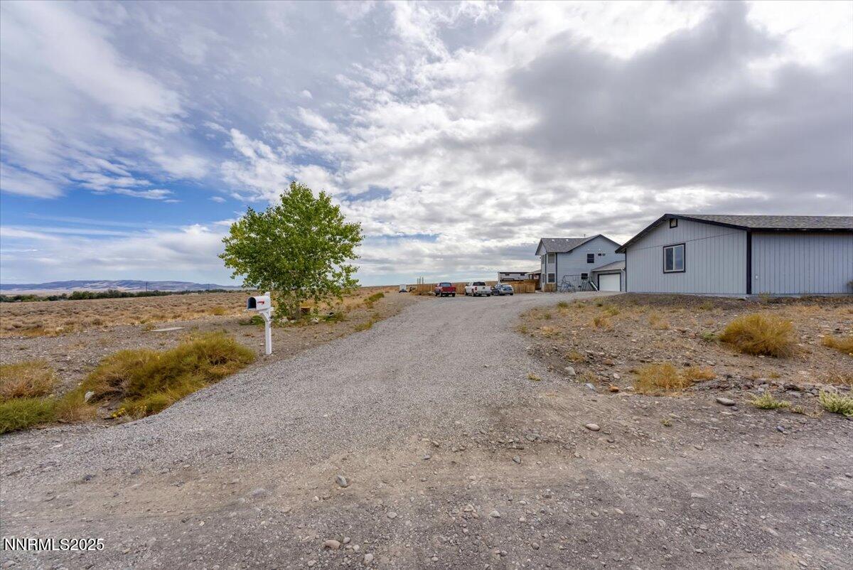 20 Simons Road Fernley, NV 89408 - Photo 33 of 56 a view of a dry yard with a large tree