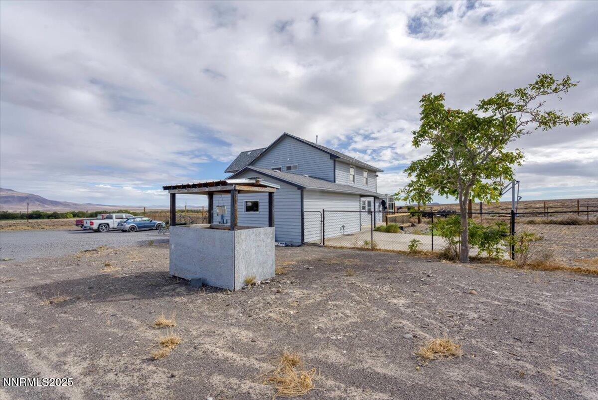 20 Simons Road Fernley, NV 89408 - Photo 40 of 56 a view of a house with a yard and wooden fence