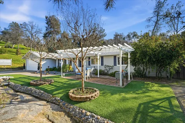 a front view of a house with a yard table and chairs