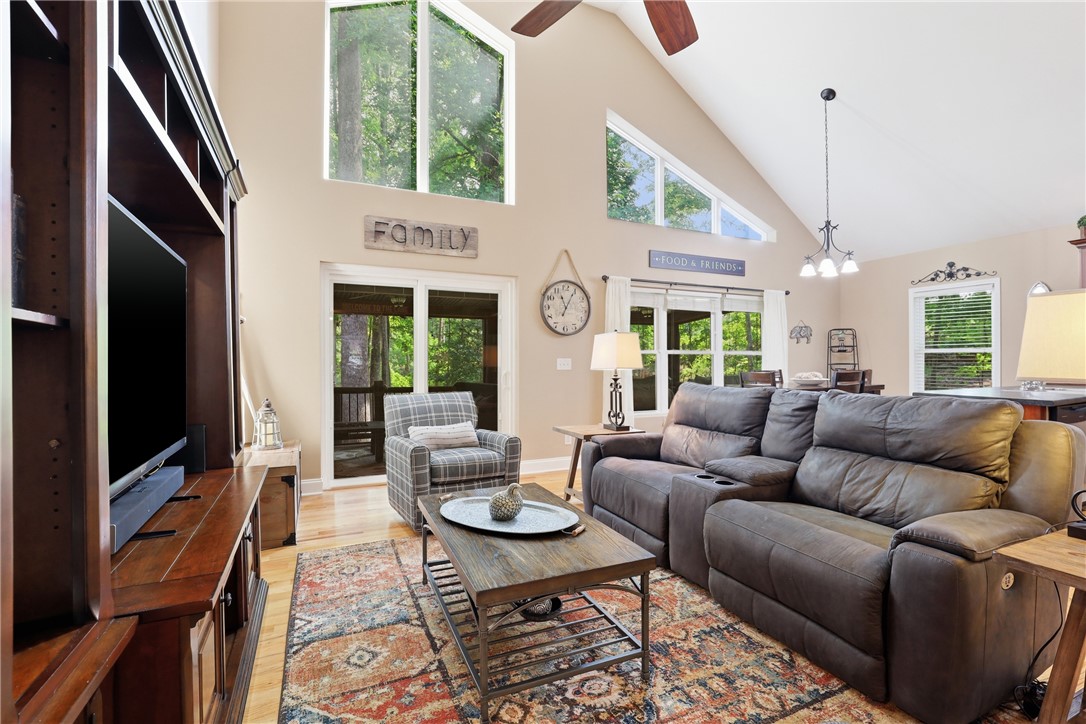 1110 Sunset Lane Anderson, SC 29626 - Photo 5 of 38 A lofty living area with vaulted ceilings and large windows provides abundant natural light.