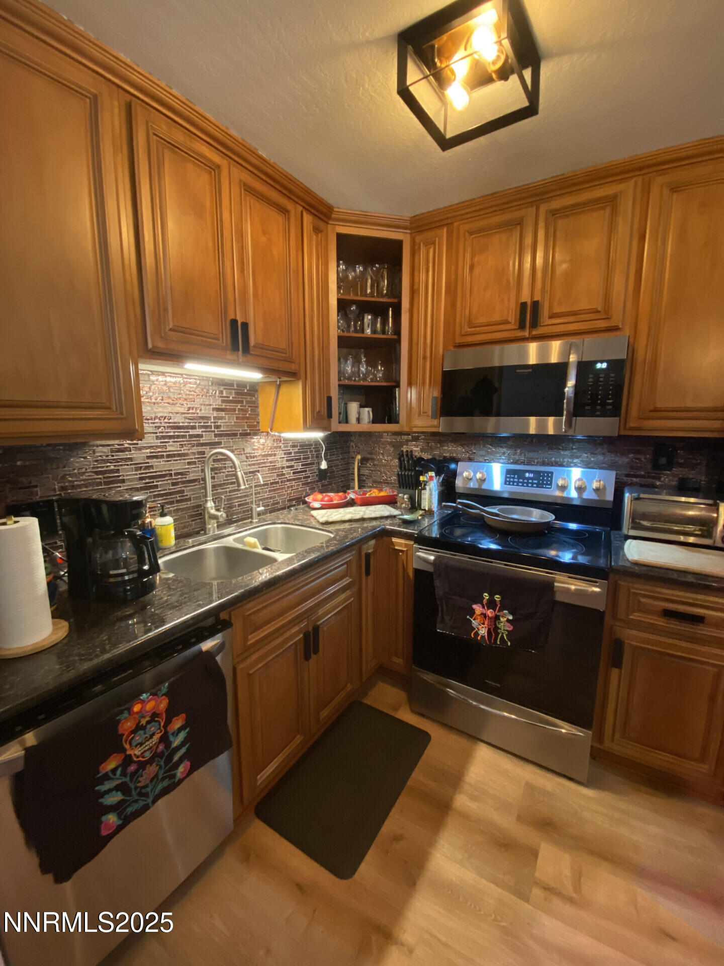 2955 Lakeside Drive, Unit 217 Reno, NV 89509 - Photo 2 of 10 a kitchen with stainless steel appliances granite countertop a stove a sink and a microwave