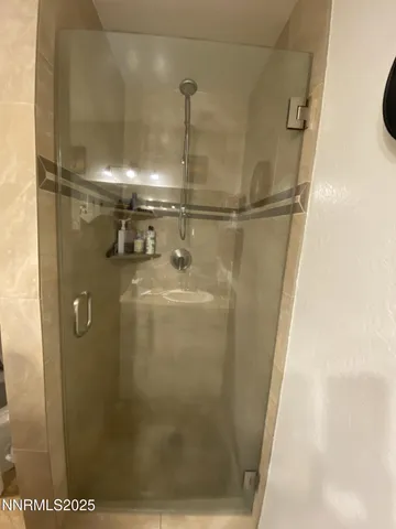 a bathroom with a glass shower door