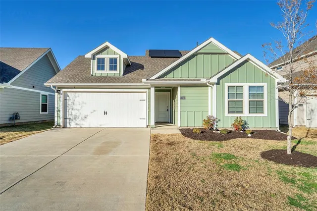 a front view of a house with yard and porch