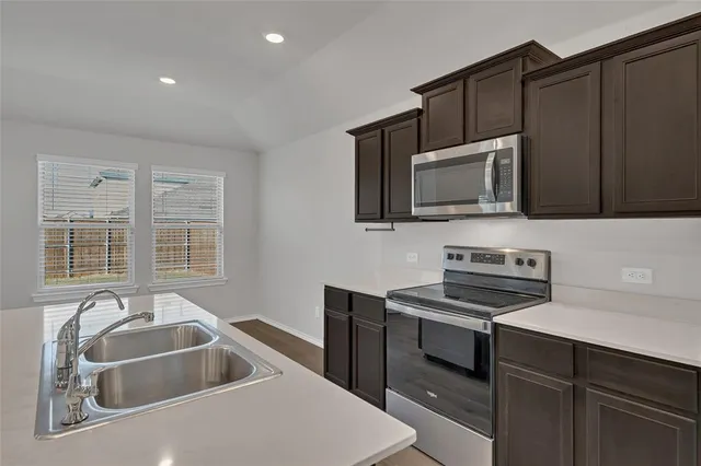 a kitchen that has a sink and a stove