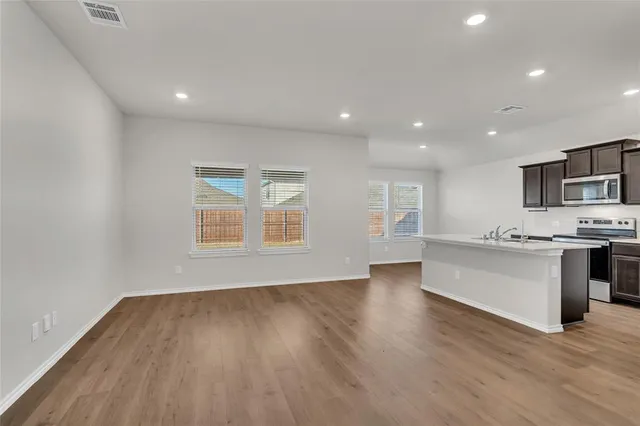 a view of kitchen with sink and wooden floor