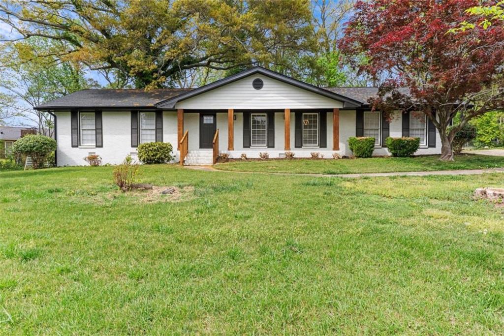 a front view of a house with a garden