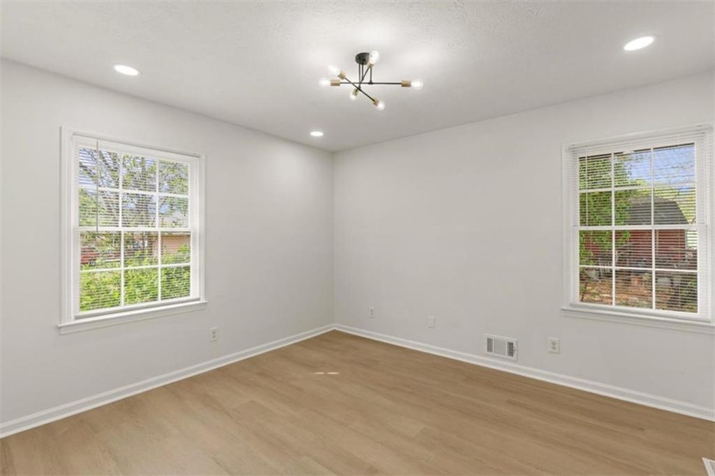 4328 Luxembourg Drive Decatur, GA 30034 - Photo 26 of 27 an empty room with wooden cabinet and windows