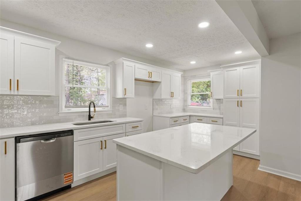 4328 Luxembourg Drive Decatur, GA 30034 - Photo 10 of 27 a kitchen with a sink a center island and cabinets