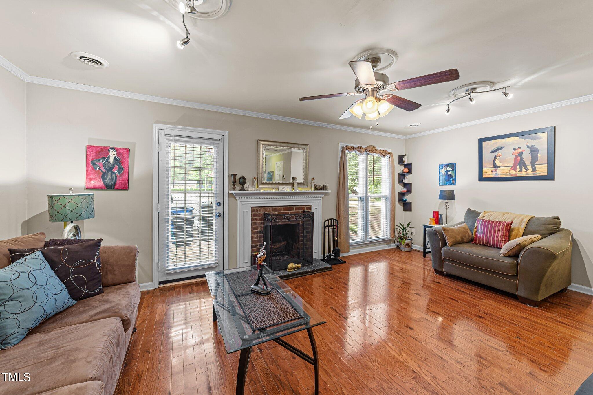 4600 Jacqueline Lane Raleigh, NC 27616 - Photo 12 of 34 a living room with furniture a fireplace and a window