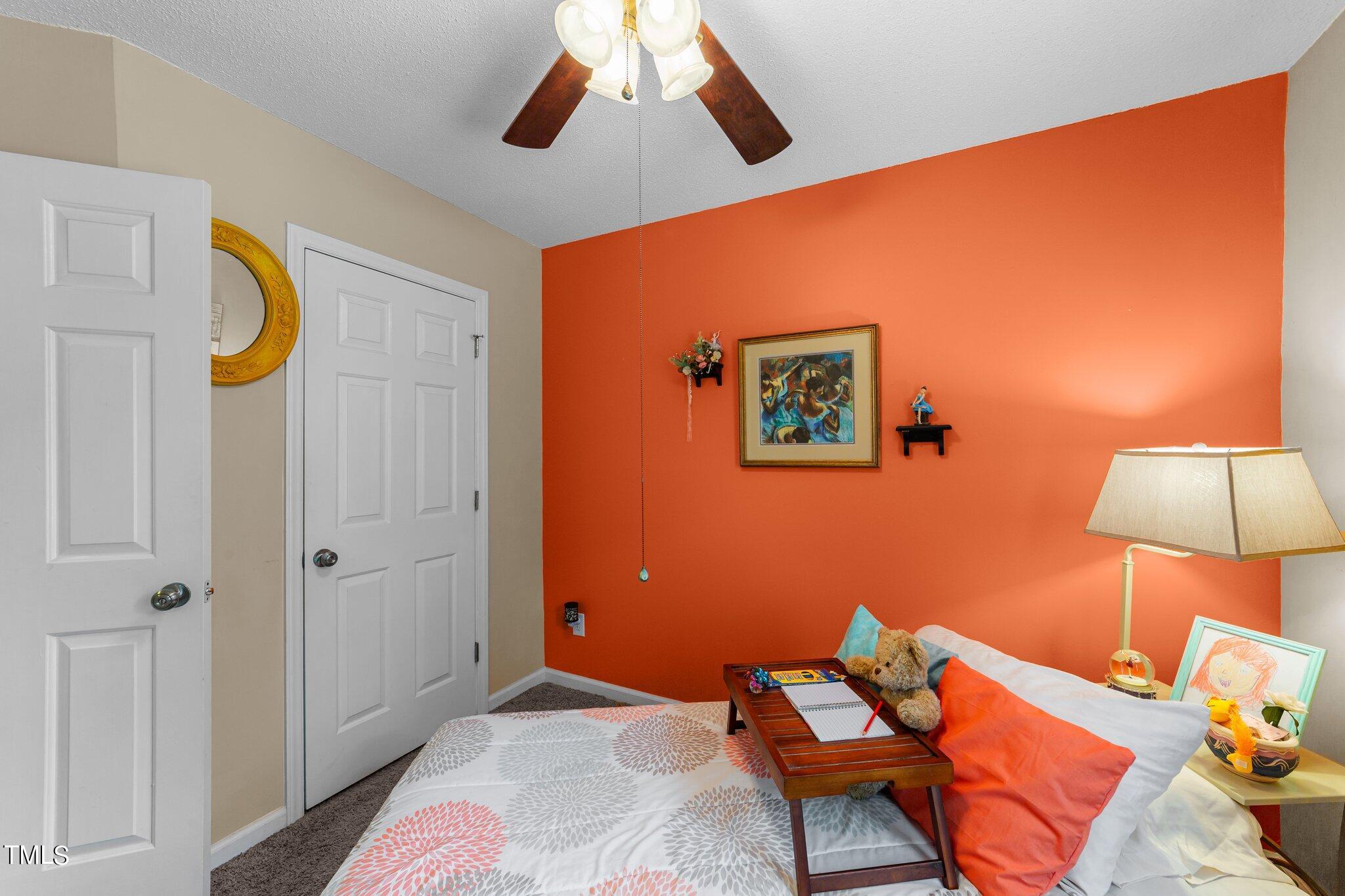 4600 Jacqueline Lane Raleigh, NC 27616 - Photo 19 of 34 a bedroom with a bed and a lamp