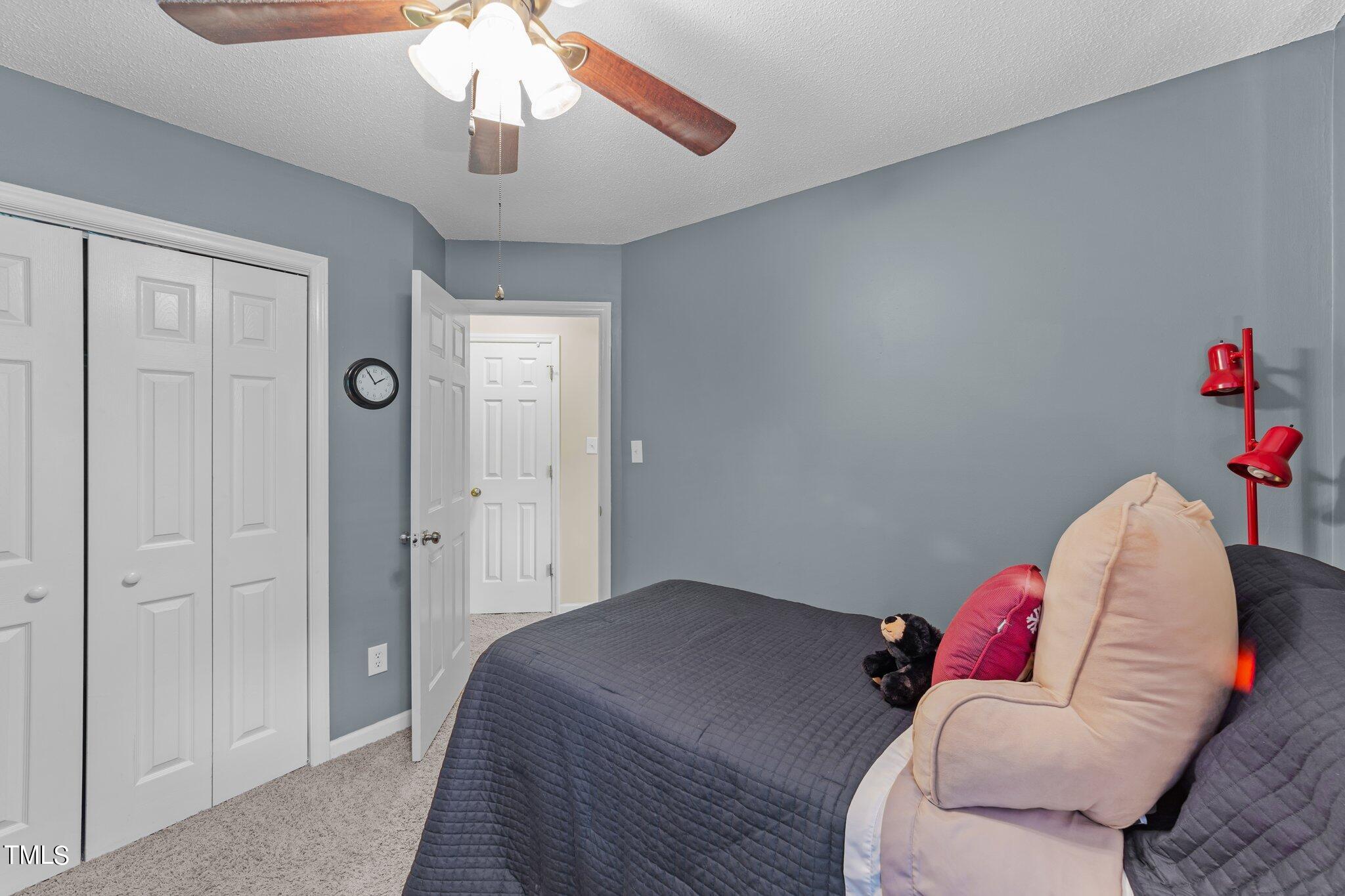 4600 Jacqueline Lane Raleigh, NC 27616 - Photo 21 of 34 a bedroom with a bed and a chandelier