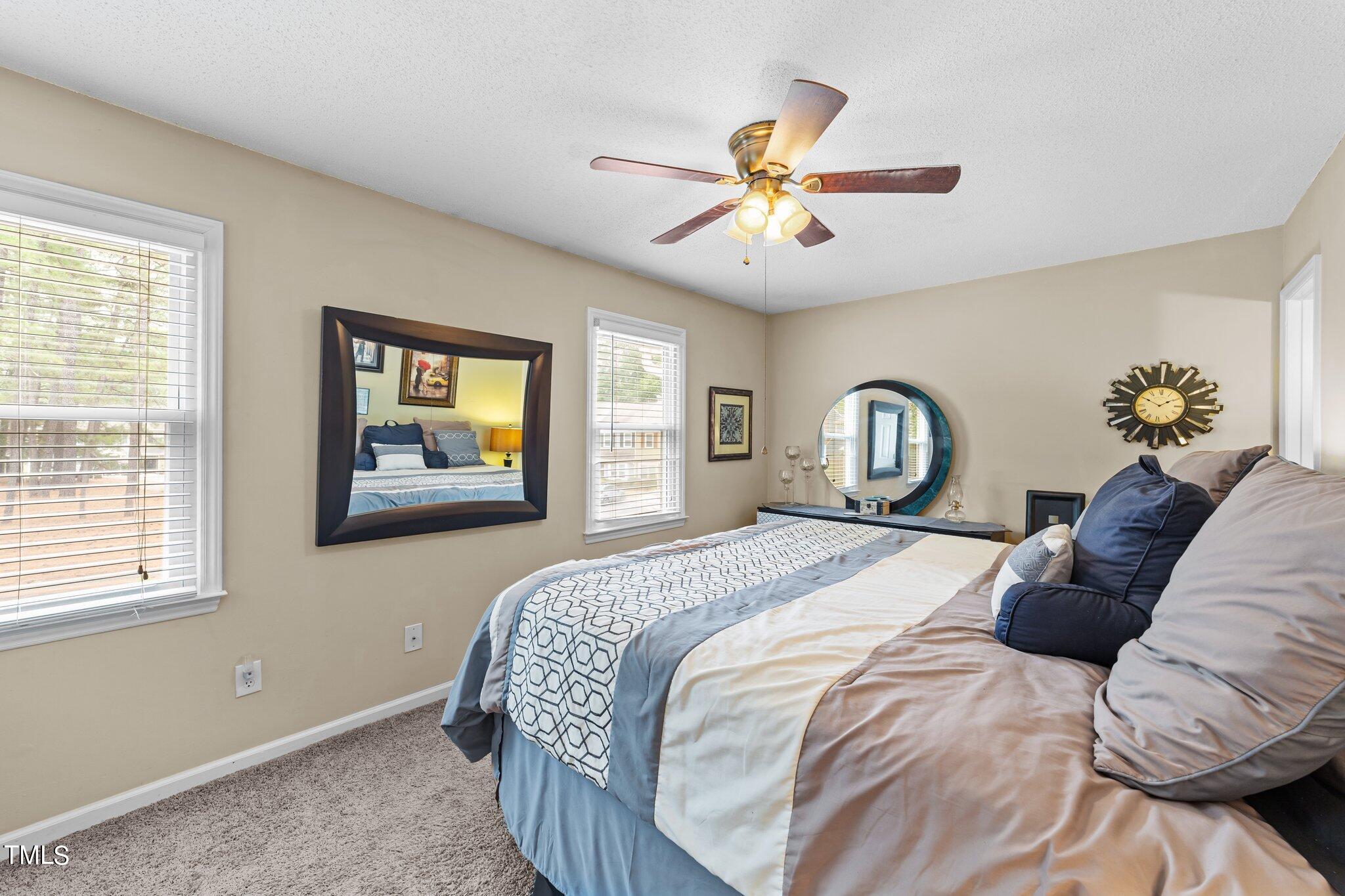 4600 Jacqueline Lane Raleigh, NC 27616 - Photo 23 of 34 a bedroom with a bed and a chandelier