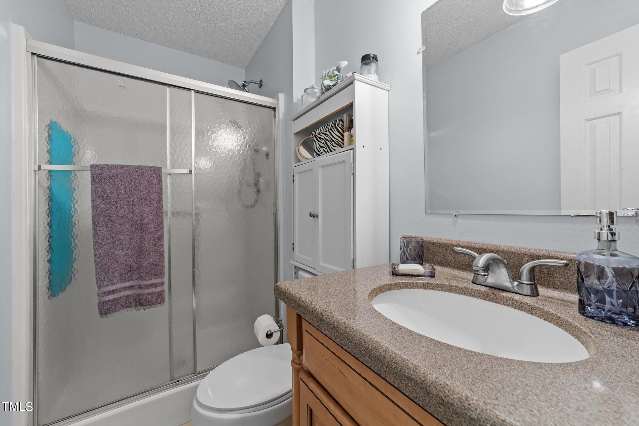 4600 Jacqueline Lane Raleigh, NC 27616 - Photo 25 of 34 a bathroom with a granite countertop sink toilet and shower