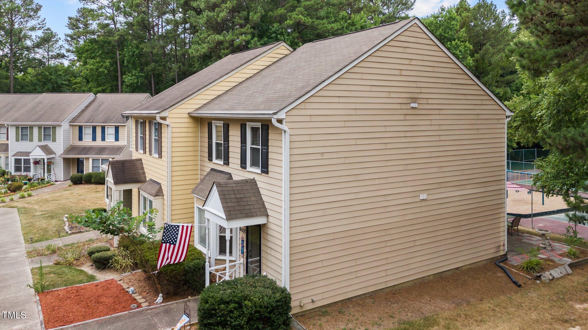 4600 Jacqueline Lane Raleigh, NC 27616 - Photo 26 of 34 a view of a white house with a small yard plants and large tree