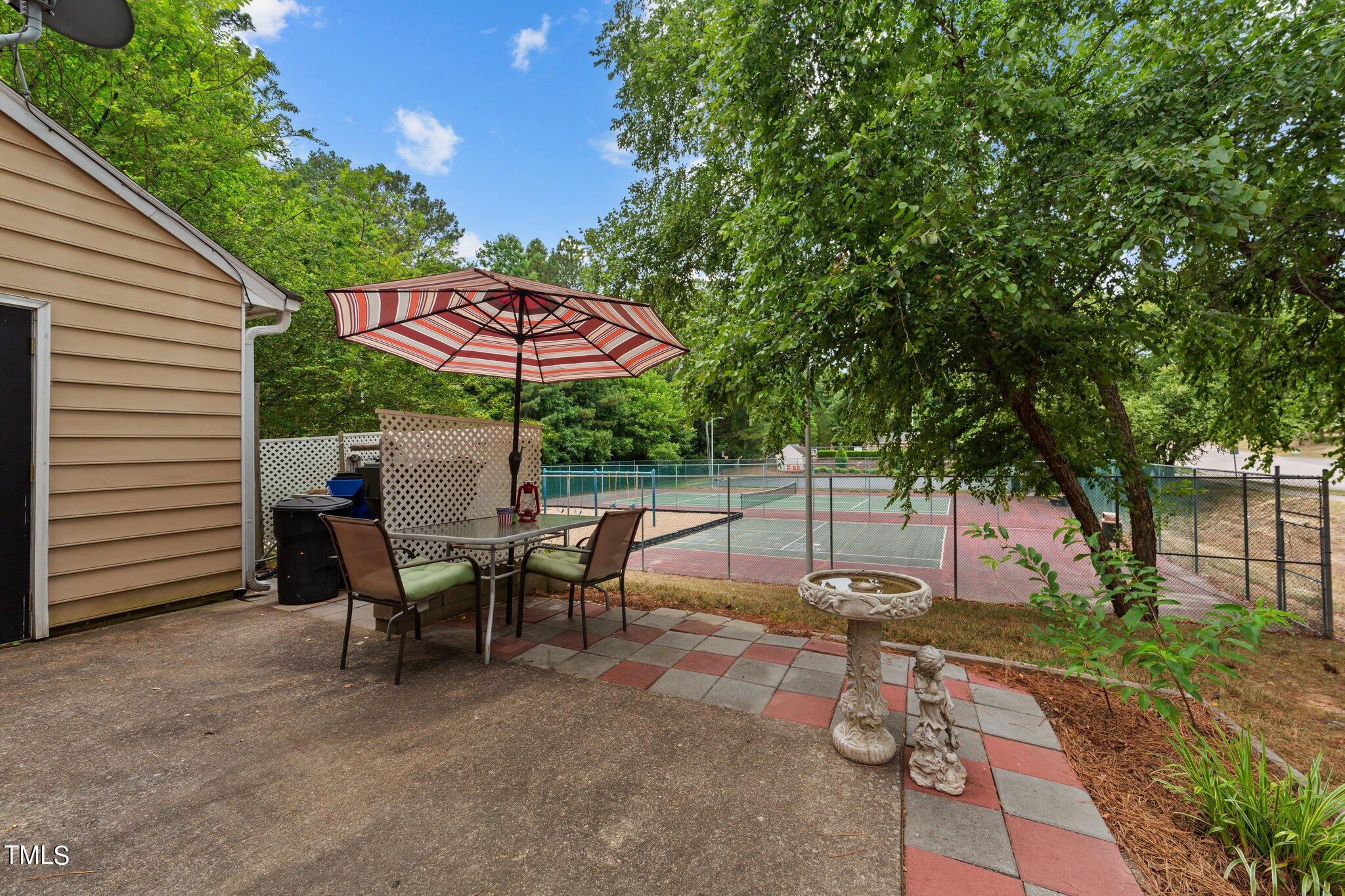4600 Jacqueline Lane Raleigh, NC 27616 - Photo 30 of 34 a view of a patio with table and chairs under an umbrella