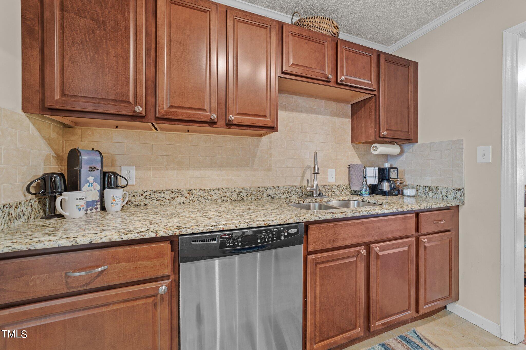 4600 Jacqueline Lane Raleigh, NC 27616 - Photo 7 of 34 a kitchen with granite countertop stainless steel appliances sink and cabinets