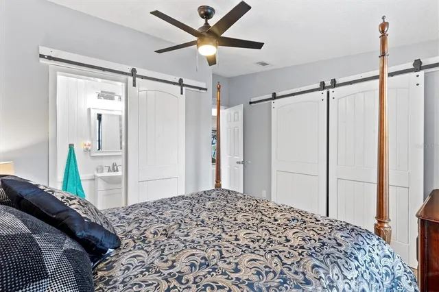 a bedroom with a bed and a chandelier