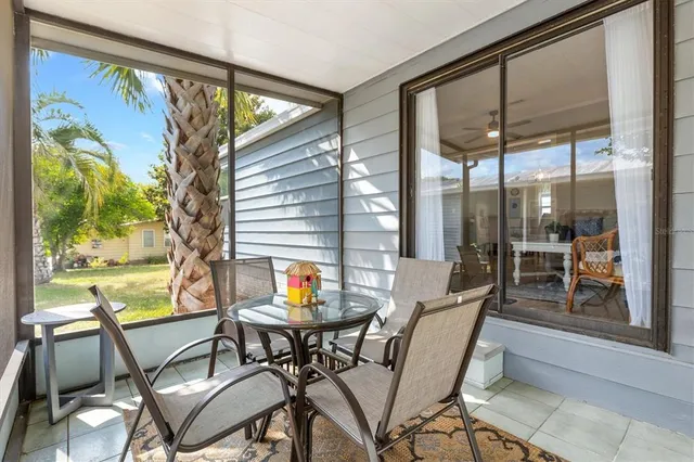 a dining room with furniture and front door