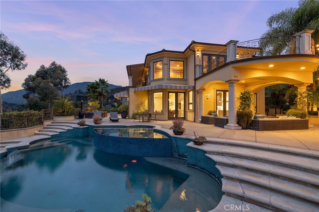 a view of a swimming pool with outdoor seating