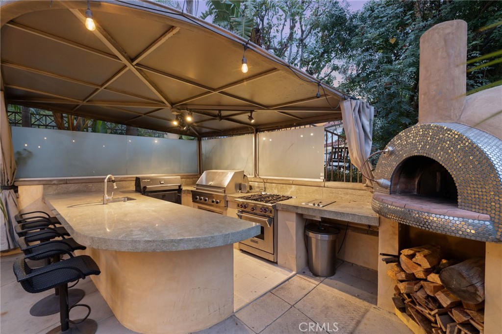 105 Oak Grove Monrovia, CA 91016 - Photo 8 of 46 a view of a patio with table and chairs under an umbrella