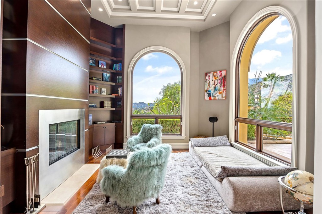105 Oak Grove Monrovia, CA 91016 - Photo 10 of 46 a living room with furniture a fireplace and a floor to ceiling window