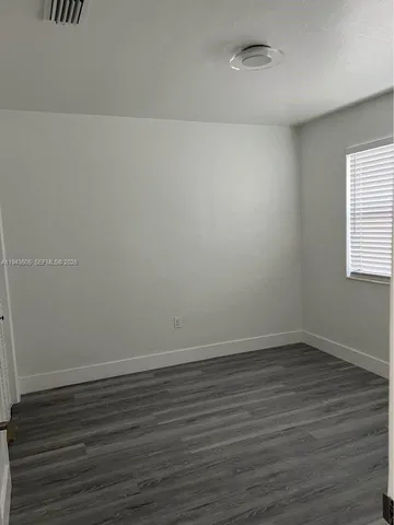 a view of an empty room and wooden floor
