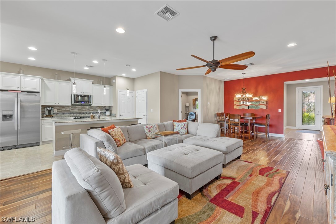 10853 Rutherford Road Fort Myers, FL 33913 - Photo 5 of 42 a living room with furniture and kitchen view