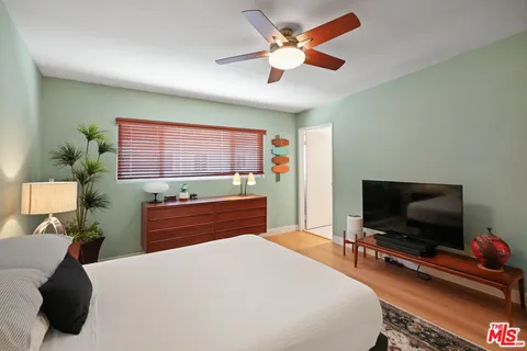 a bedroom with a bed and a flat screen tv