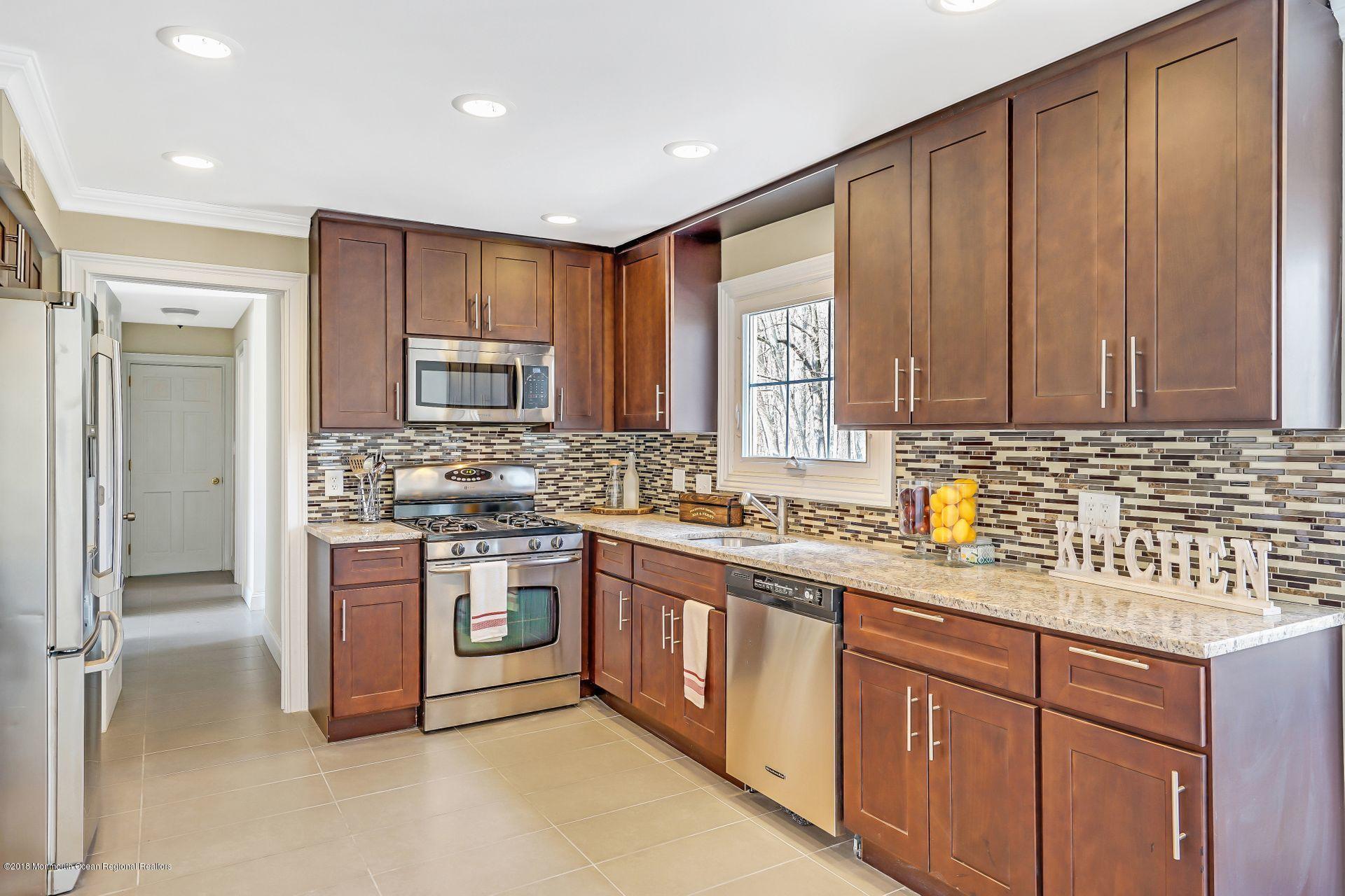 8 Saddle Ridge Road Colts Neck, NJ 07722 - Photo 12 of 35 a kitchen with stainless steel appliances granite countertop a stove a sink dishwasher and a refrigerator