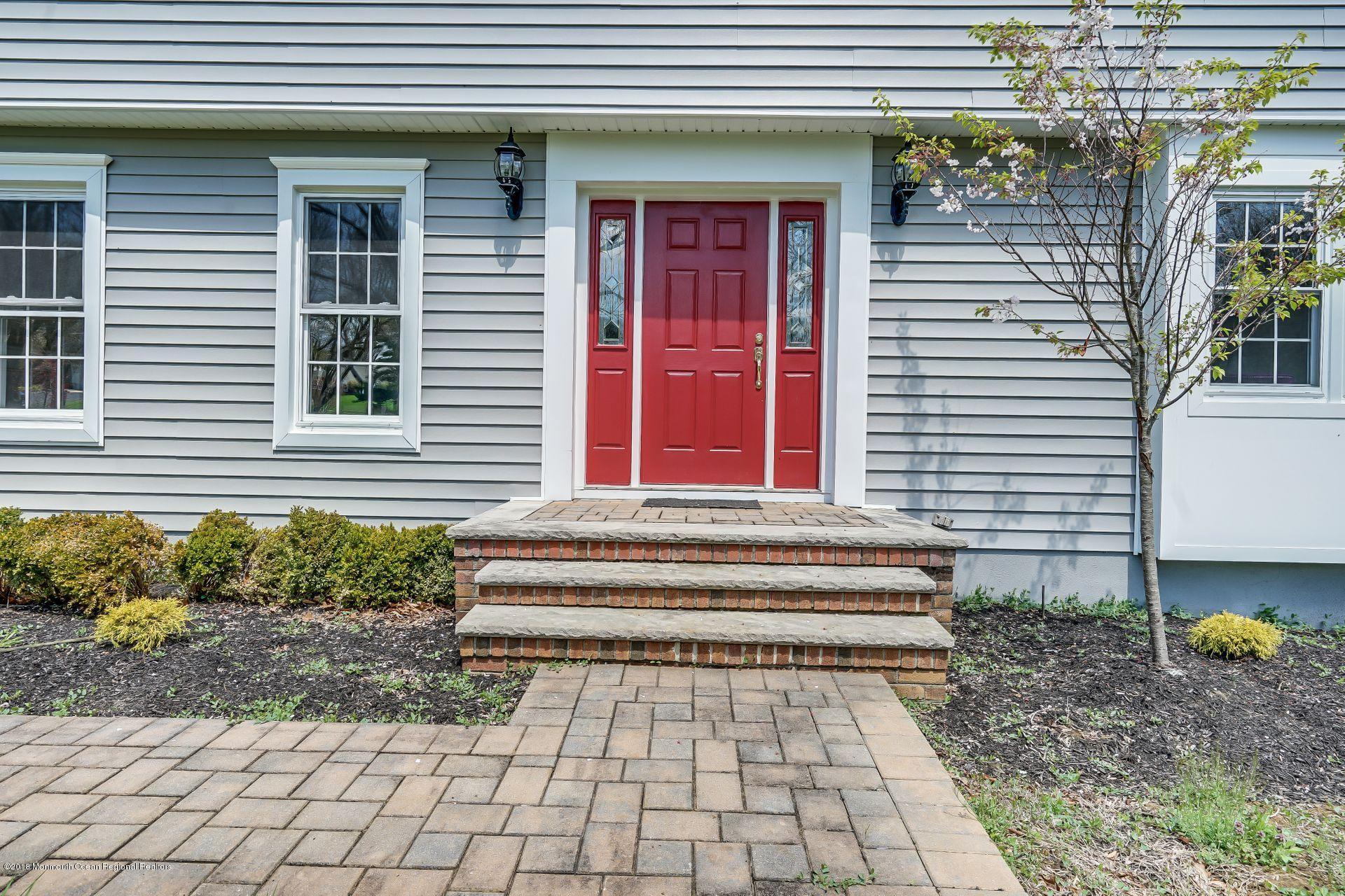 8 Saddle Ridge Road Colts Neck, NJ 07722 - Photo 2 of 35 a front view of a house with a yard and potted plants