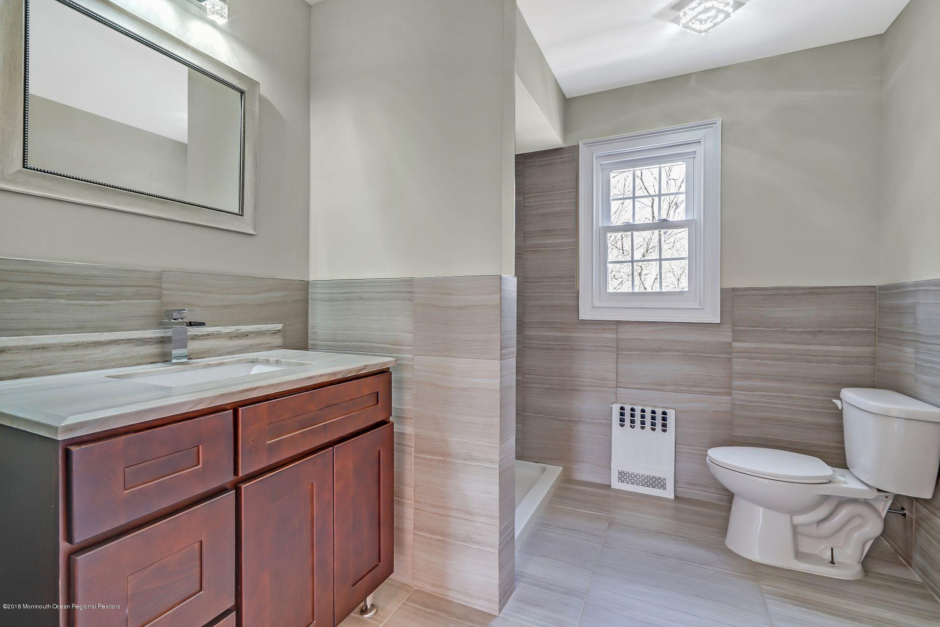 8 Saddle Ridge Road Colts Neck, NJ 07722 - Photo 21 of 35 a bathroom with a toilet a sink and mirror