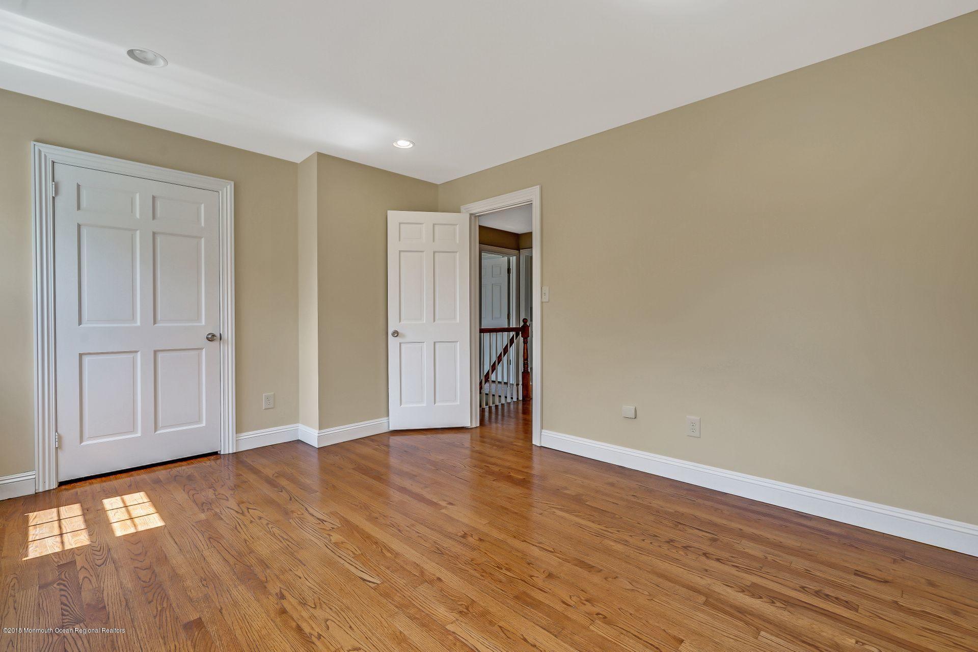 8 Saddle Ridge Road Colts Neck, NJ 07722 - Photo 24 of 35 a view of an empty room with wooden floor