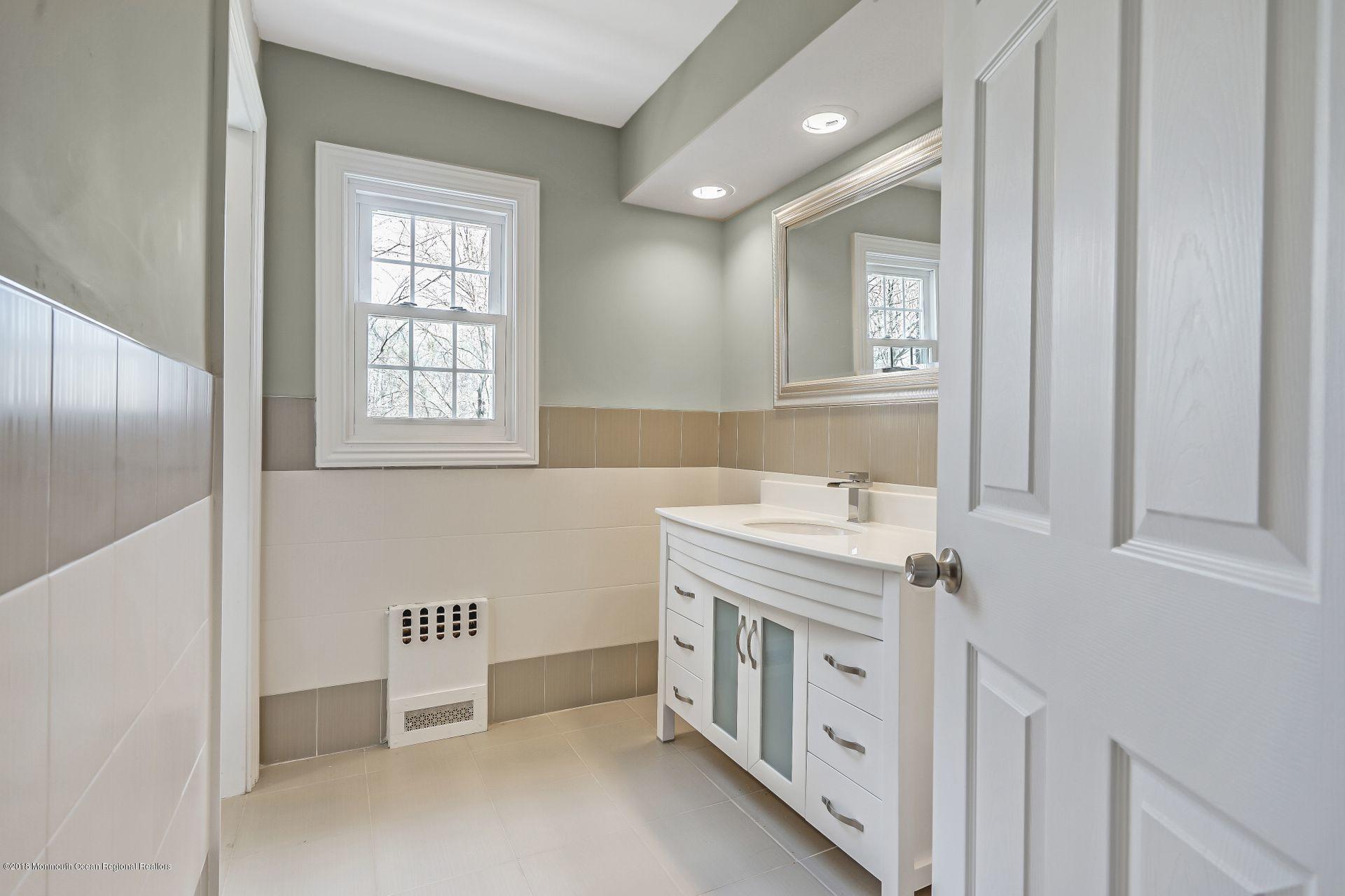 8 Saddle Ridge Road Colts Neck, NJ 07722 - Photo 25 of 35 a bathroom with a sink and a mirror